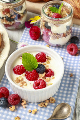 Wall Mural - Breakfast table: bowl of yogurt with muesli and fresh fruits