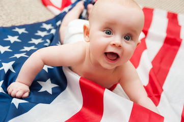 Wall Mural - adorable baby girl lying on american flag background