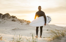 A Surfer With His Surfboard