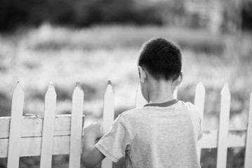 Wall Mural - Close up happy face of boy outdoor in the sunset time black and white