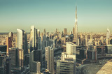 Fototapeta  - Fantastic architectural background. Panoramic Dubai cityscape with skyscrapers at sunset. Scenic travel background.