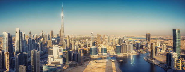 Wall Mural - Scenic panoramic view of Dubai modern architecture at sunset. Aerial daytime cityscape with downtown skyscrapers.