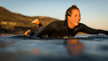 Close-up Of Woman Paddling On Surfboard, Malibu, California, America, USA