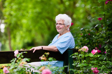 Senior lady in rose garden