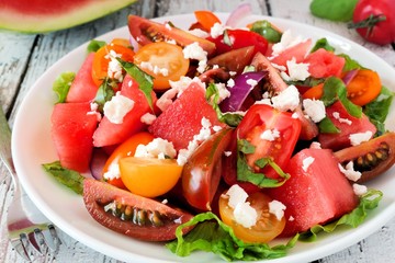 Wall Mural - Watermelon and colorful mixed tomato salad with feta cheese close up