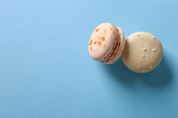 Wall Mural - Tasty macaroons on light blue background