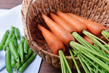 Fresh carrots in wicker basket, closeup