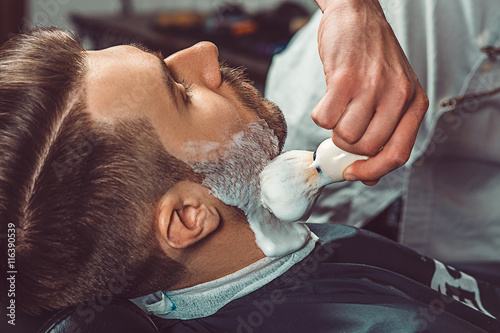 Hipster client visiting barber shop Canvas Print