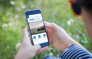 Poster - girl in grass holding her smartphone with web design interface