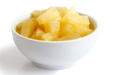 Canned Pineapple Pieces In A Ceramic Bowl Isolated On White.