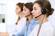 © rogerphoto - Call center operator.Young beautiful business woman in headset.