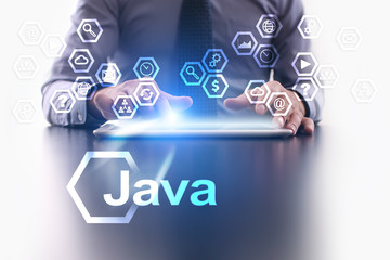 businessman is using tablet pc and selecting java icon.