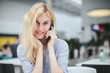 © stock.film - beautiful girl talking on the phone sitting in a shopping center, business center