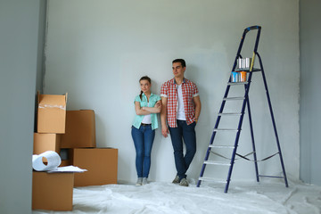 Portrait of young couple moving in new home