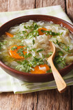Fototapeta Kuchnia - Cabbage soup with vegetables close up in a bowl. vertical
