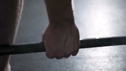 Wall Mural - Closeup of young man doing barbells deadlift exercise at the gym