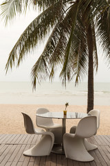 set of modern white beach chair and table on the beach, vacation concept