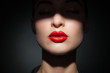 © julenochek - Beautiful model with bright red lips and face half covered in shadow