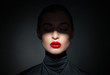 © julenochek - Beautiful model with bright red lips and face half covered in shadow