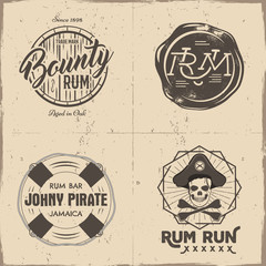 Set of vintage handcrafted pirates emblems, labels, logos. Isolated on a scratched paper background. Sketching filled style. Pirate and sea symbols - rum bottle, barrel, skull. Vector