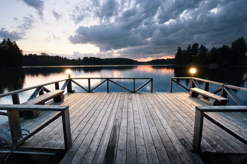 Wall Mural - wooden pier with lanterns leaving the lake