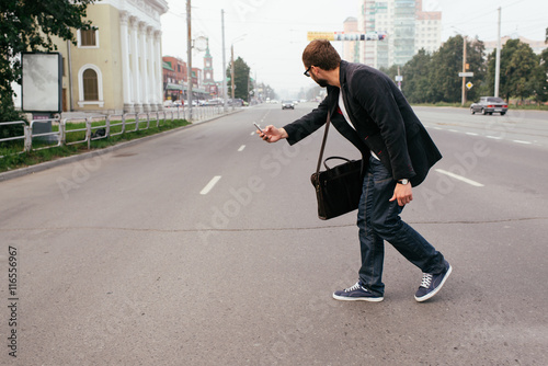 Juliste people playing on the phone in the game with augmented reality, the risk to get