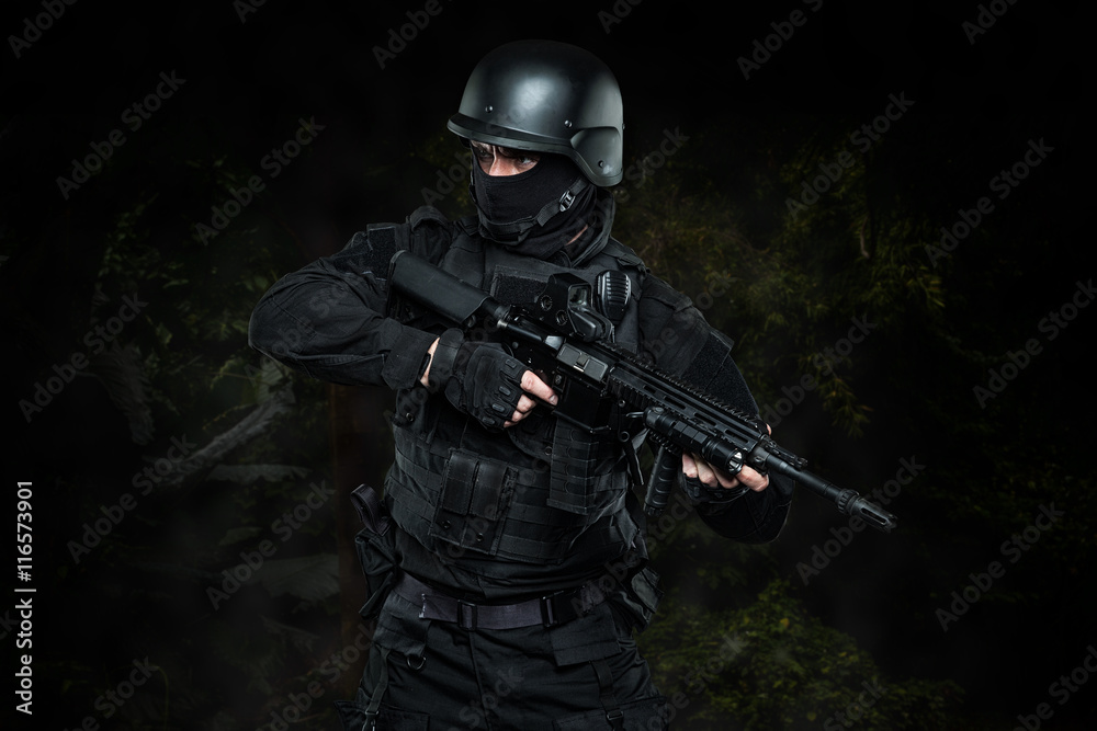 Spec ops police officer SWAT in black uniform and face mask - obrazy, fototapety, plakaty 