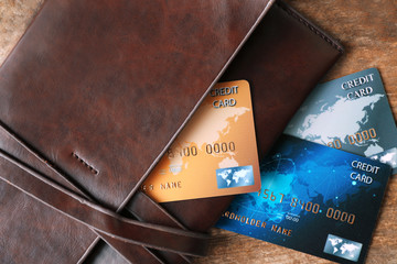 Wall Mural - Credit cards in leather wallet on wooden background