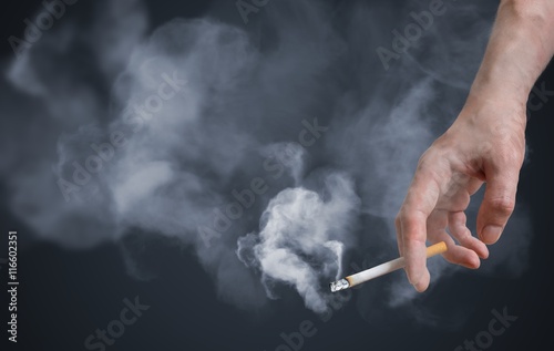 Fotomural Smoker is holding smoking cigarette in hand