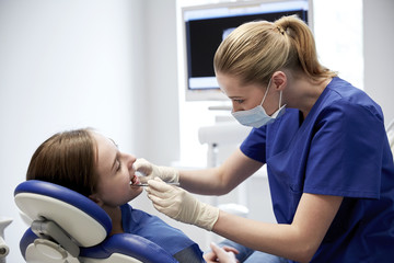 Sticker - female dentist checking patient girl teeth