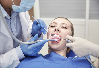 Sticker - close up of dentist treating female patient teeth