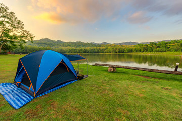Wall Mural - camping tents in nature background with sunset scenic view at la