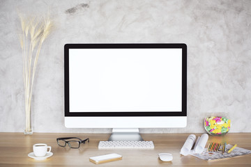 Desk with blank white monitor