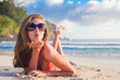 © el.rudakova - long haired girl in bikini on tropical Seychelles beach blowing air kiss