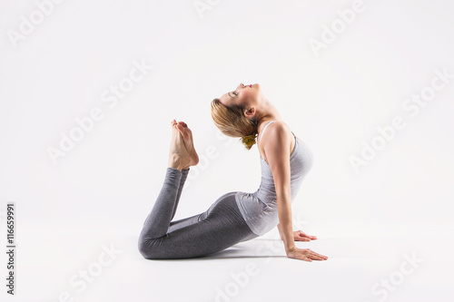 Leinwand Poster Beautiful young woman doing yoga. Isolated on white