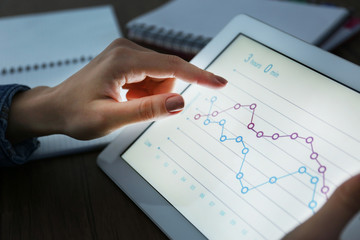 Canvas Print - Female hands holding tablet with business diagram