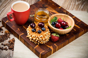 Wall Mural - Waffles with berries on wooden background