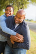 © digitalskillet1 - African American Father Playing Football With His Son.