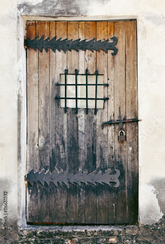 Weathered Wooden Door Of An Old Abandoned Building Like A Prison