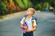 © fisher05 - Elementary school student with books. Behind the boy's school backpack.