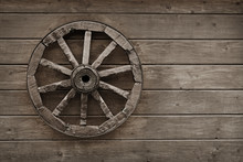 Old Wagon Wheel On Wooden Wall