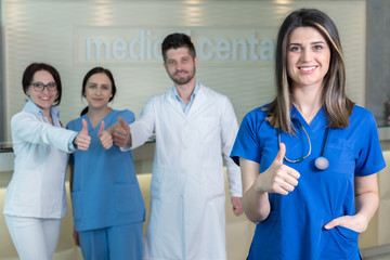 Wall Mural - Attractive female doctor in front of medical group .