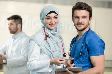 Wall Mural - Saudi arab doctors working with a tablet.