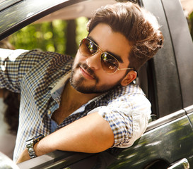 Wall Mural - Portrait of young man in car.