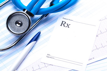 Empty prescription  lying on table with stethoscope