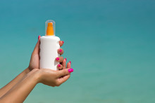 Woman Hands Putting Sunscreen From A Suncream Bottle