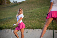 Beautiful Young Girl Playing Golf In Sand Trap On Course.