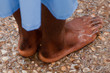 Yardenit, Israel - 29 Decembre 2012: wet feet of a man after his baptism in the Jordan River. The man wears the traditional blue robe of the christened