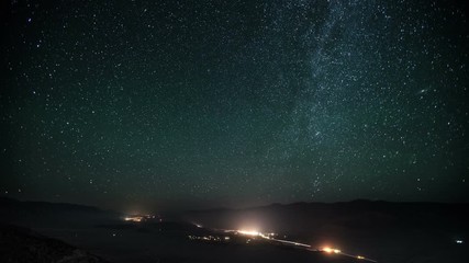 Wall Mural - Time lapse of a road going the desert with the night sky moving above.