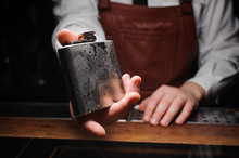 Barman Holding Ice Cold Flask